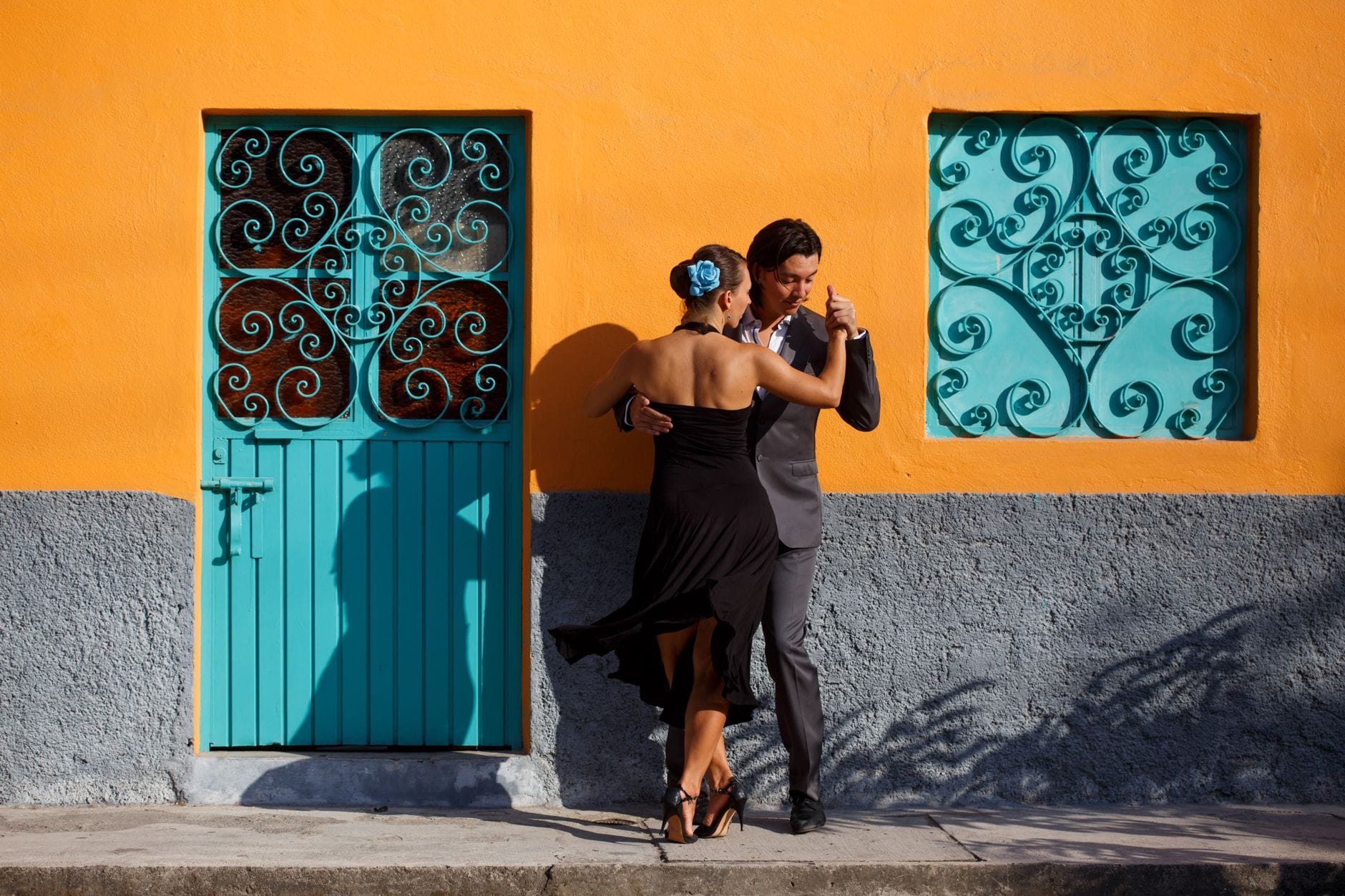 Para tańcząca tango przy kolorowej ścianie w miejskiej scenerii